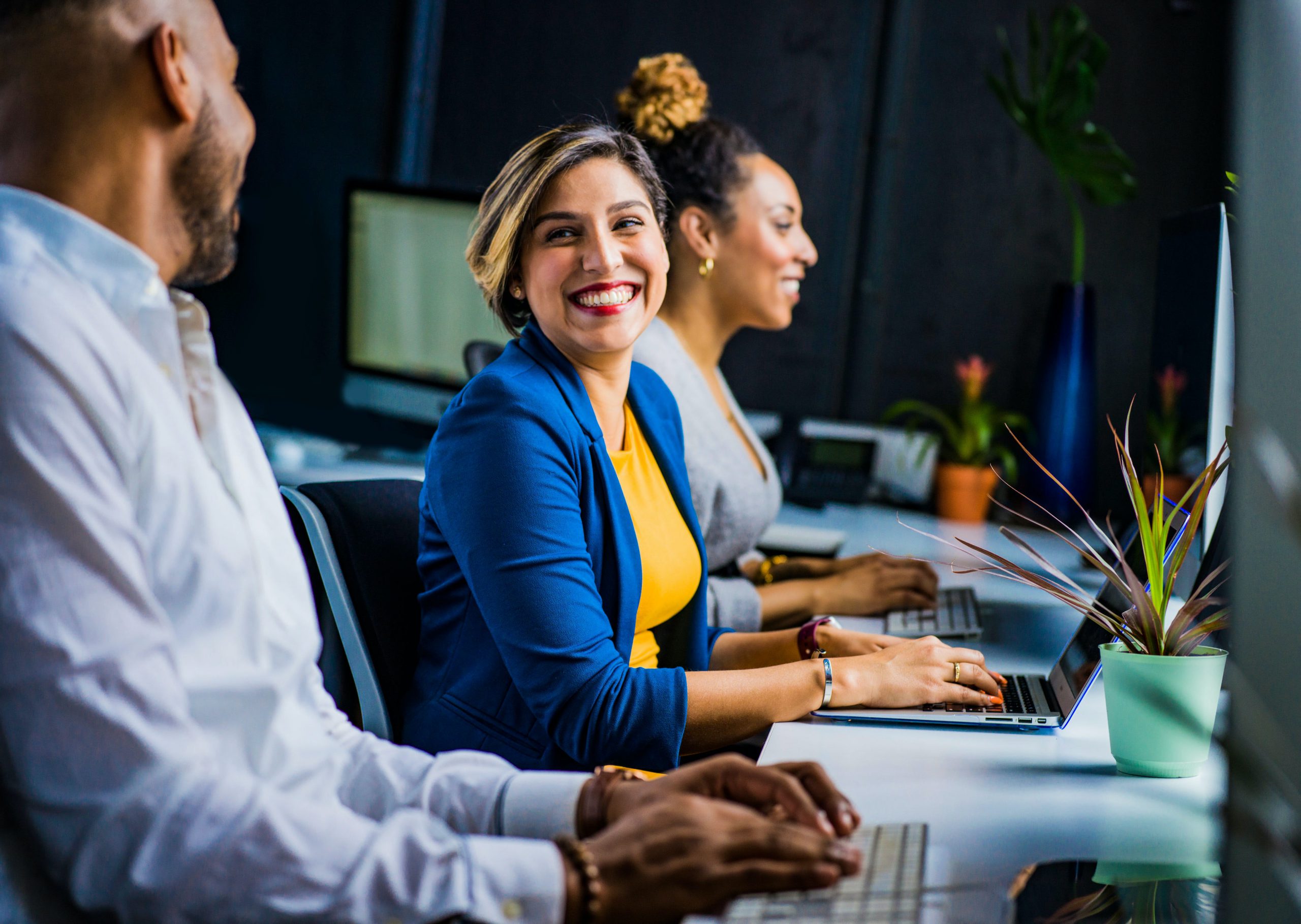 Two colleagues smiling at each other in an office